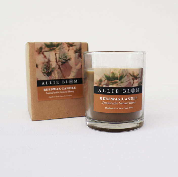 Allie Blom Beeswax Candle, scented with natural honey, in a glass jar on a white background.